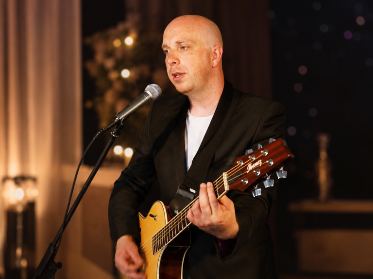 Ben Field singing and playing acoustic guitar