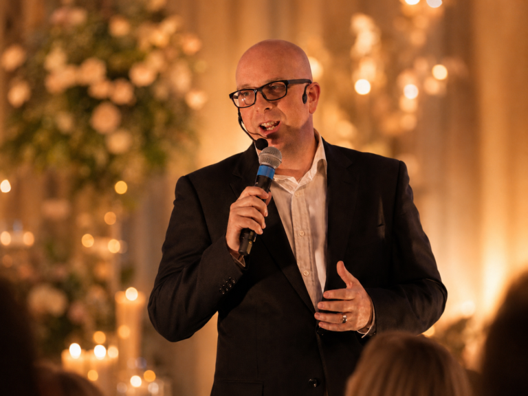 Ben Field hosting an event with a microphone